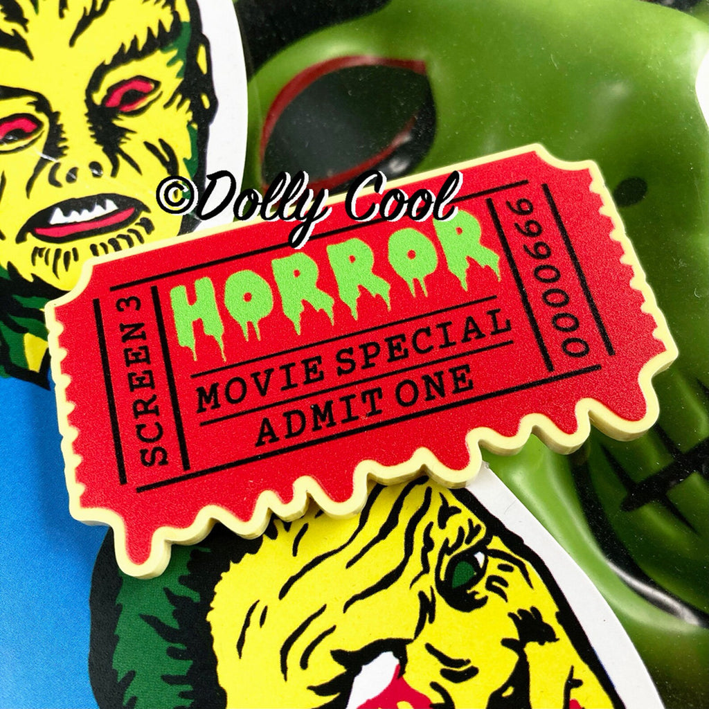 Brooch of a 50's horror movie ticket